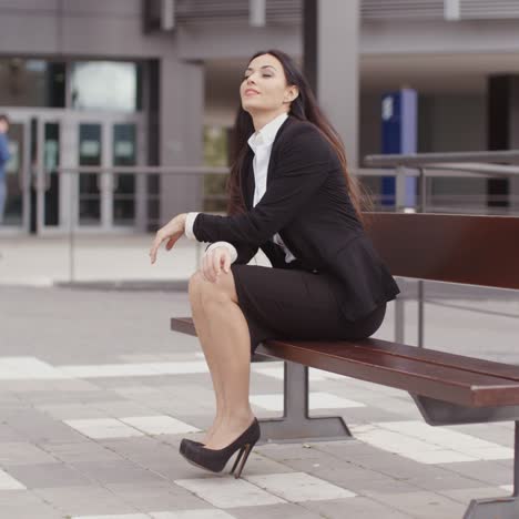 Calm-business-woman-sitting-outdoors