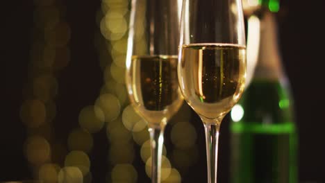 Champagne glasses and decorations on black background at new year&#039;s eve