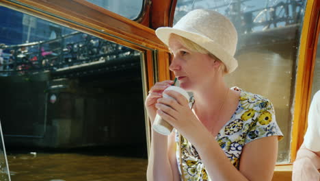 a woman drinks coffee amsterdam cruise