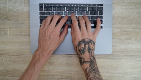 birds eye view of male hands getting frustrated typing on keyboard