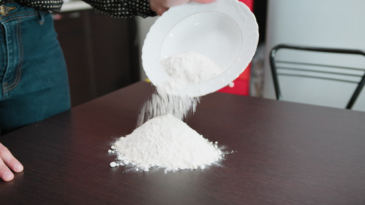 Woman Adds Italian Flour On The Table For The Preparation Of A Typical Dessert
