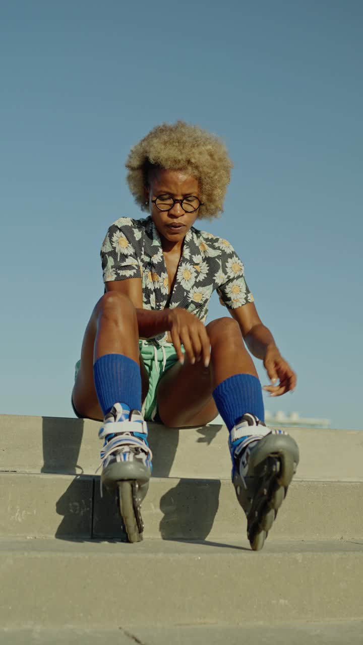 A woman putting on roller skates outdoors
