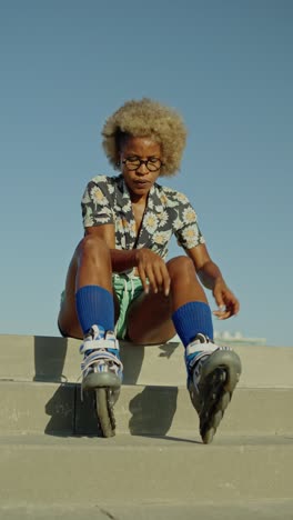 a woman putting on roller skates outdoors