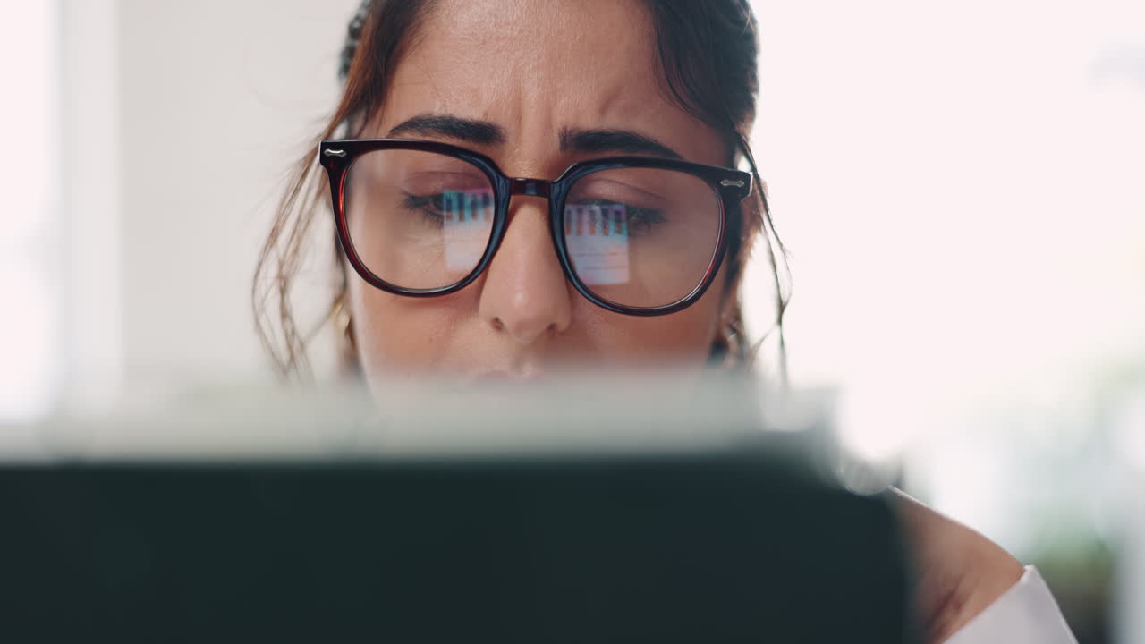Woman wearing glasses working at a computer