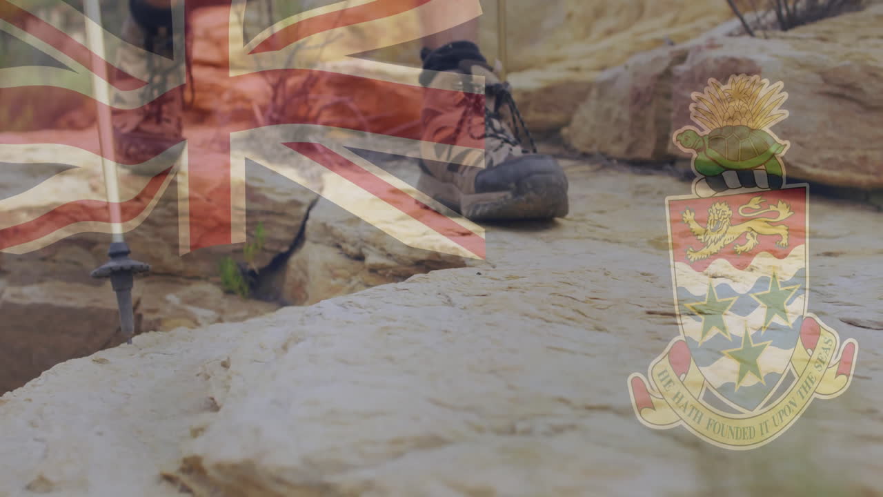 Hiking wearing boots on rocky terrain with British flag and Cayman Islands crest