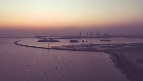 orange sunset with karachi port seen from seaview beach