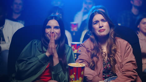 smiling girls spending time in movie theater.