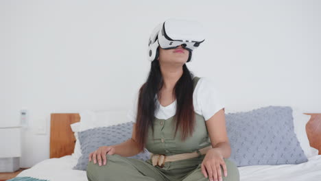 using vr headset, asian woman sitting on bed in relaxed spa environment, at home, copy space
