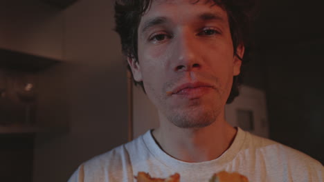 close-up of a man eating a burger