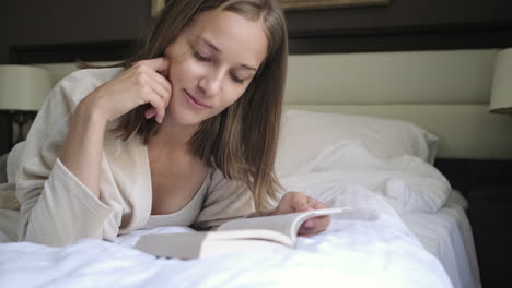 woman reading a book in bed