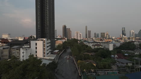khlong saen saep boat service through phrom phong downtown in bangkok, thailand. aerial drone shot