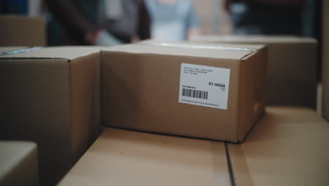 logistics and shipping: hands sorting cardboard boxes