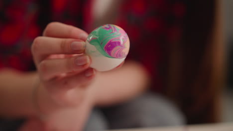 artist turns vibrant easter egg with marbling patterns