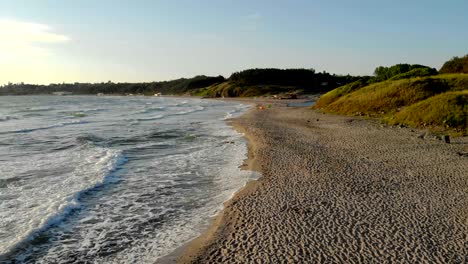 waves crashing on sand at sunrise during vacation at bulgaria.