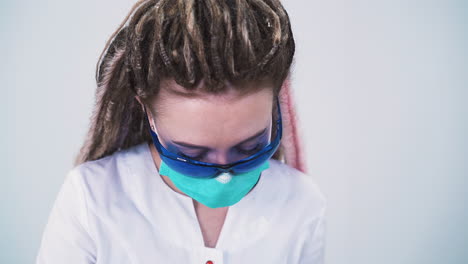 dermatologist-with-dreadlocks-does-laser-epilation-in-clinic