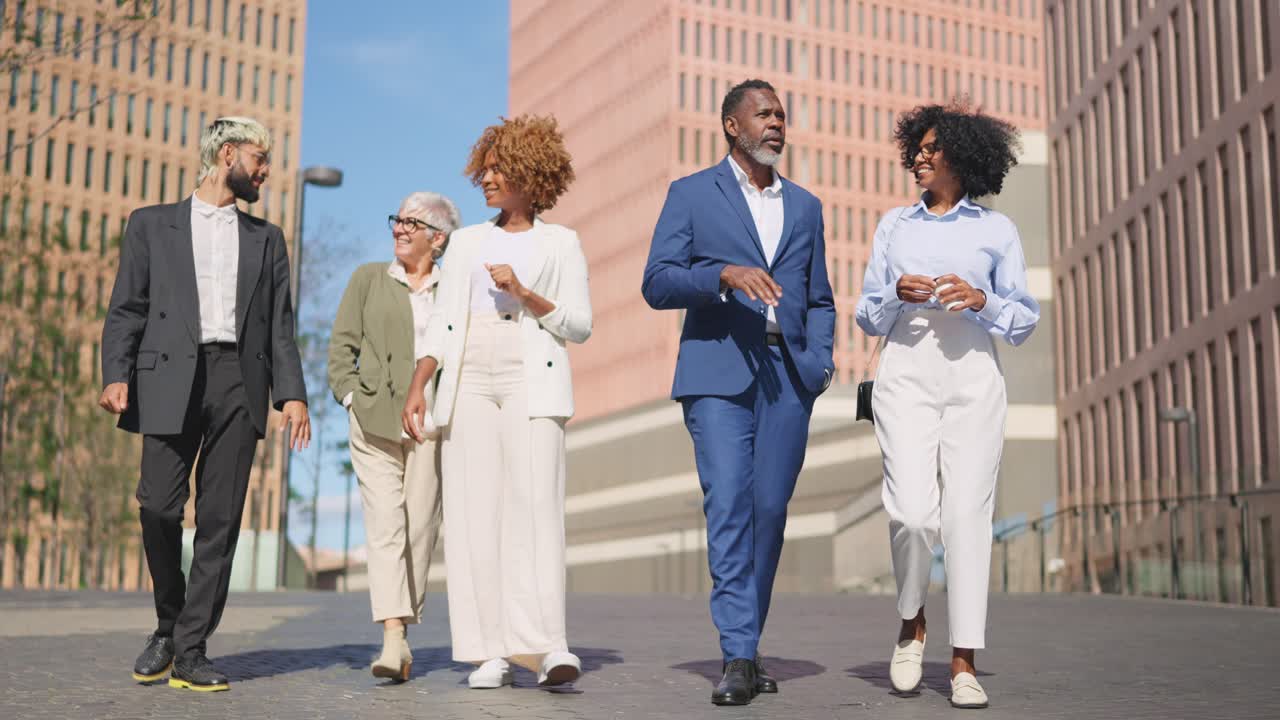 Multicultural global business people walking together along a financial district