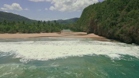 Aerial-view-of-San-Juan-river-mouth-flowing-into-Caribbean-Sea-during-sunlight