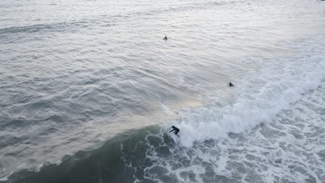 aerial of surfer riding gnarly wave in cold water of iceland