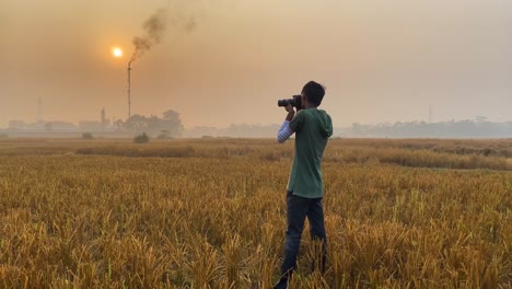 cinematic view of photographer taking pictures of polluting industrial area