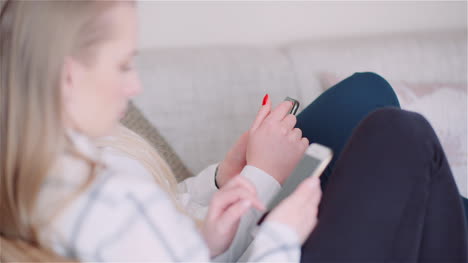 Two-Young-Women-Doing-Online-Shopping-On-Smartphone-Browsing-Internet-Social-Media