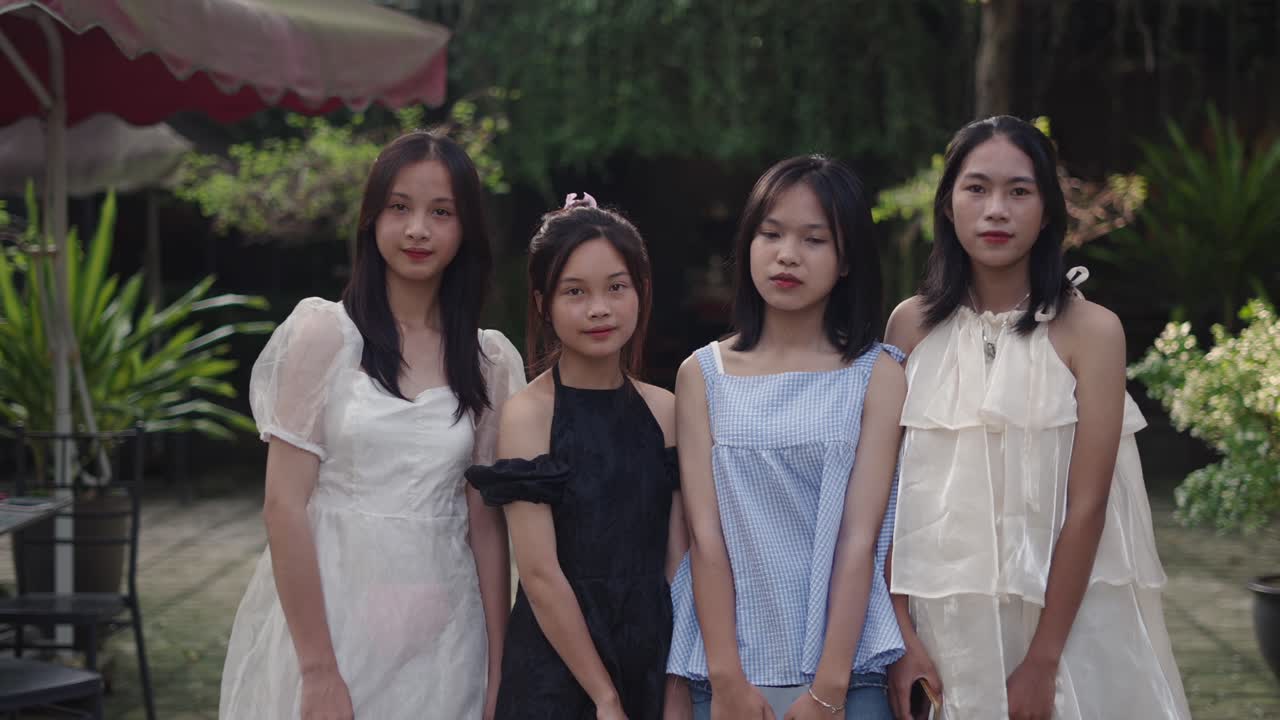 Four Teenage Girls Posing Outdoors