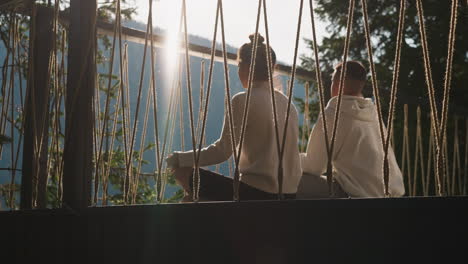 couple enjoying sunset view from balcony