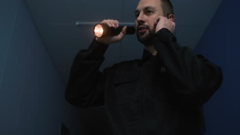 man in uniform searching on the hallway