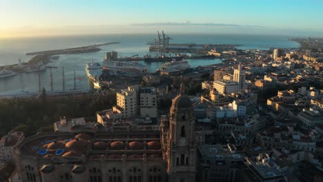 Aerial-drone-cathedral-and-panoramic-Harbor-of-Malaga-Andalusia-Spain-town-Buildings-sea-port-in-Sunset-skyline,-Spanish-moorish-historic-town