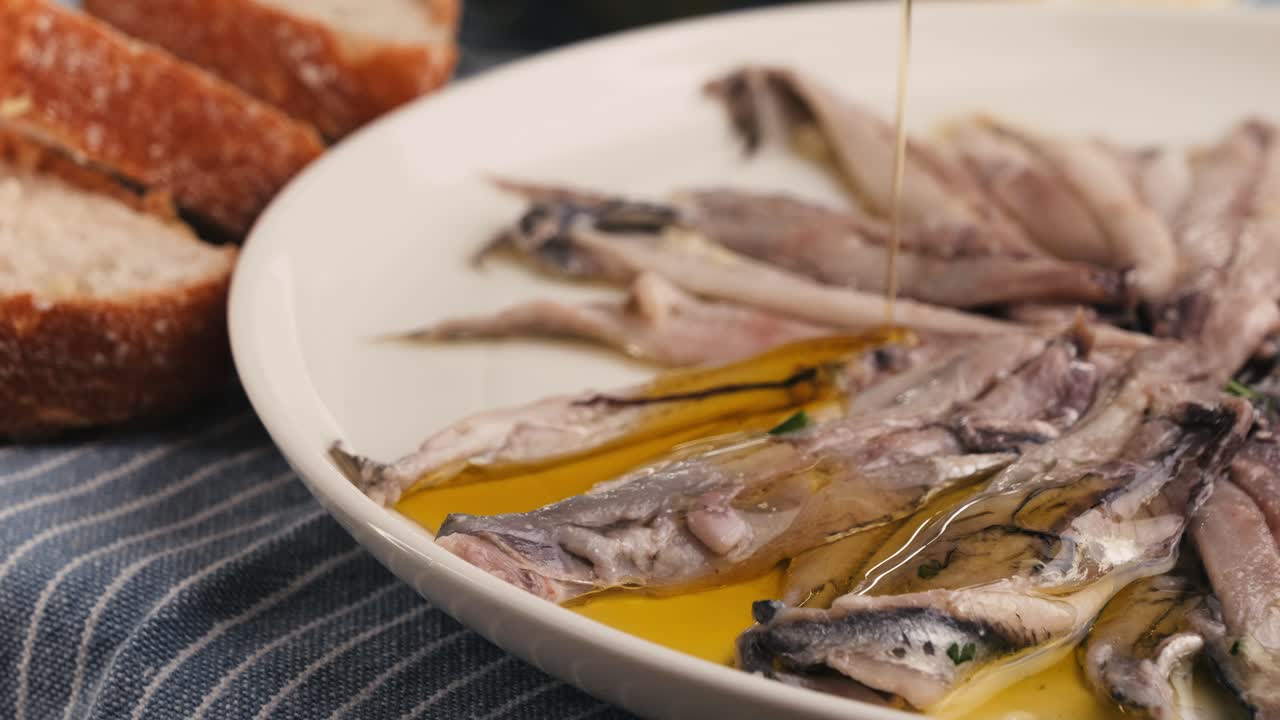 Fresh Sea sardines and Anchovy Fish and Mullus On Display On Ice On Market Store Shop. Seafood Fish Background, close up stand of small salty white fish.