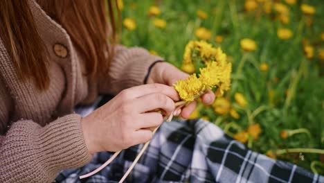 child making a dandelion flower crown