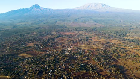 sunrise- kenya landscape with a village, kilimanjaro and amboseli national park - tracking, drone aerial view