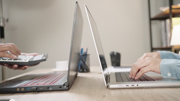 Close up Shot of Businesswoman hands typing on laptop computer keyboard for searching information,online communication support,marketing research,business report in the office desk at night.