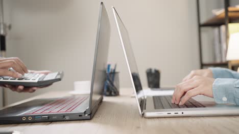 close up shot of businesswoman hands typing on laptop computer keyboard for searching information,online communication support,marketing research,business report in the office desk at night.