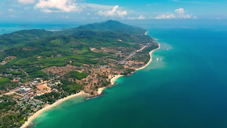 4K-Cinematic-nature-drone-footage-of-a-panoramic-aerial-view-of-the-beautiful-beaches-and-mountains-on-the-island-of-Koh-Lanta-in-Krabi,-South-Thailand,on-a-sunny-day