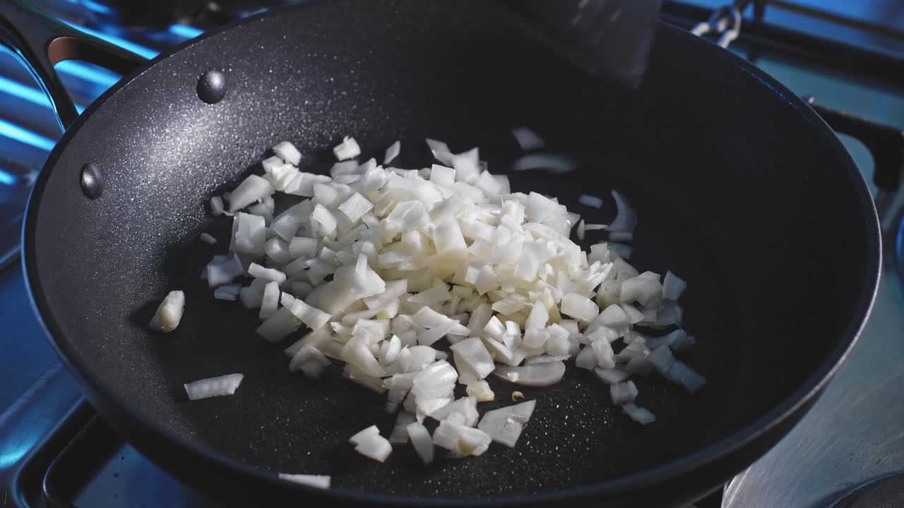 Spraying Coconut Oil Onto Non-stick Pan Then Saute Chopped Onions And Mushroom