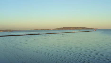 aerial flying over low tide ocean in ireland during sunset, truck right