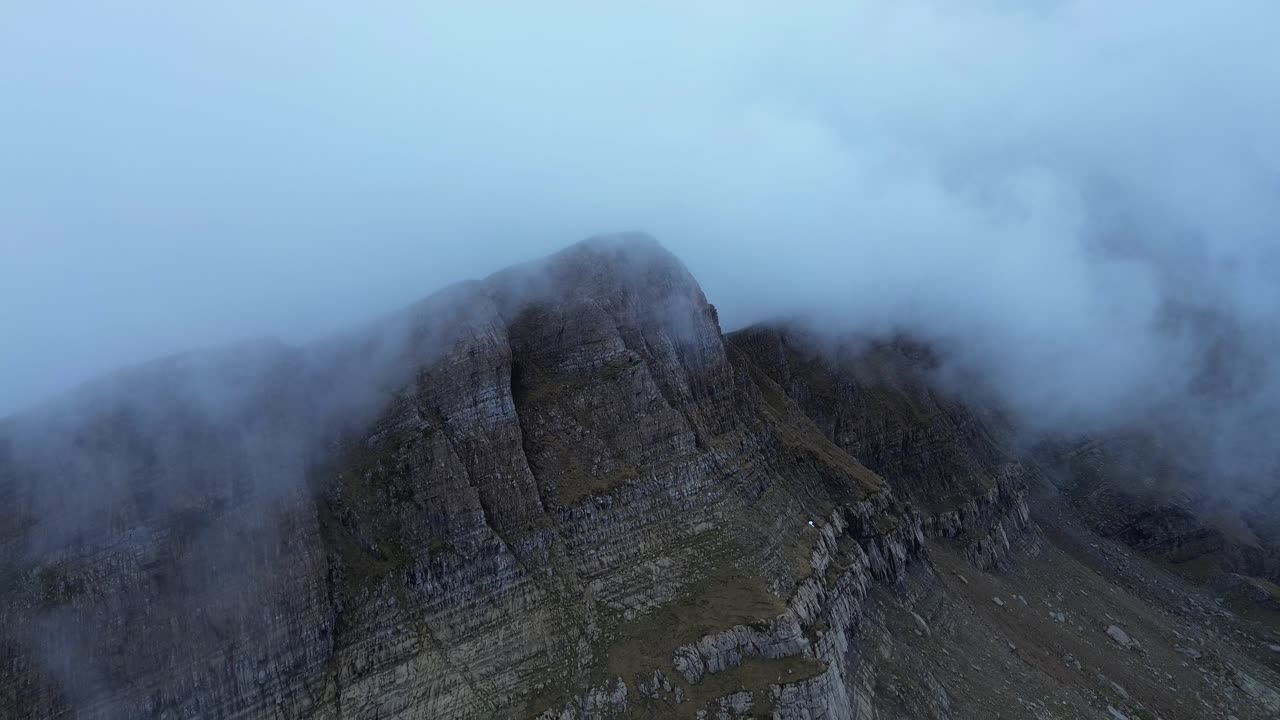 Misty clouds surround the rugged Pico Tortiellas mountain in Aragón, Spain creating a dramatic view