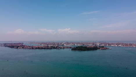 Aerial-view-of-the-Venice,-drone-cinematic-orbit-shot-at-daytime-showcasing-the-iconic-islands-separated-by-the-turquoise-lagoons-and-canals