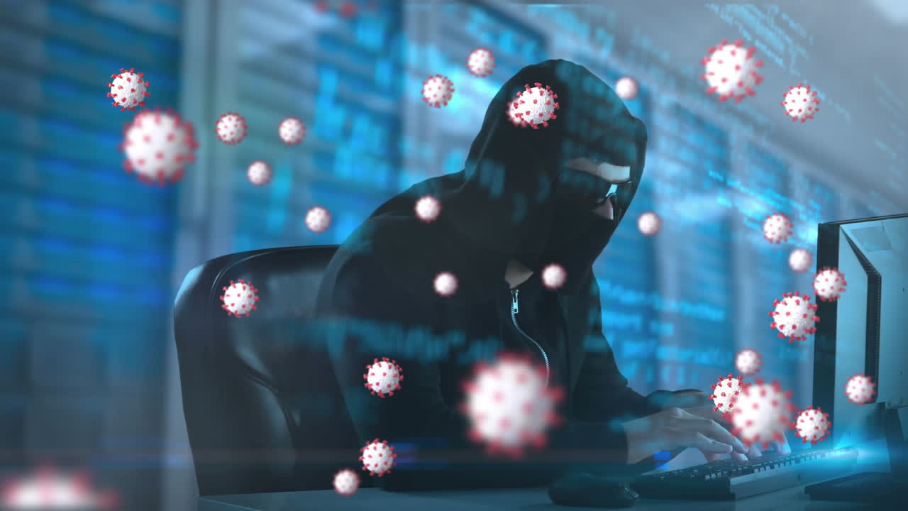 노트북을 사용하여 발라클라바를 입은 남성에 대한 거대한 코로나19 세포의 애니메이션