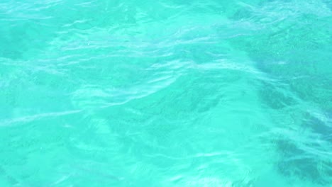 turquoise water texture as boat cruises through clear water