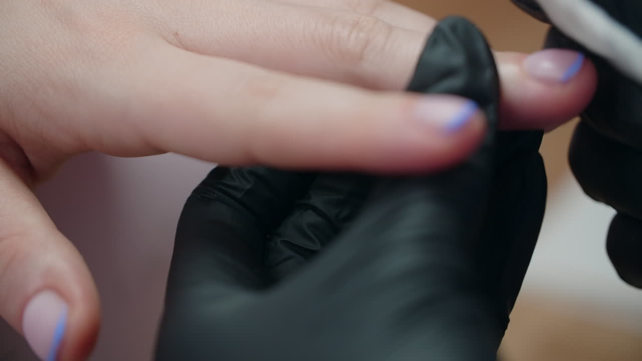 Woman getting a French manicure with blue accent