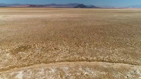 aerial view of fast flight over desert salt flats