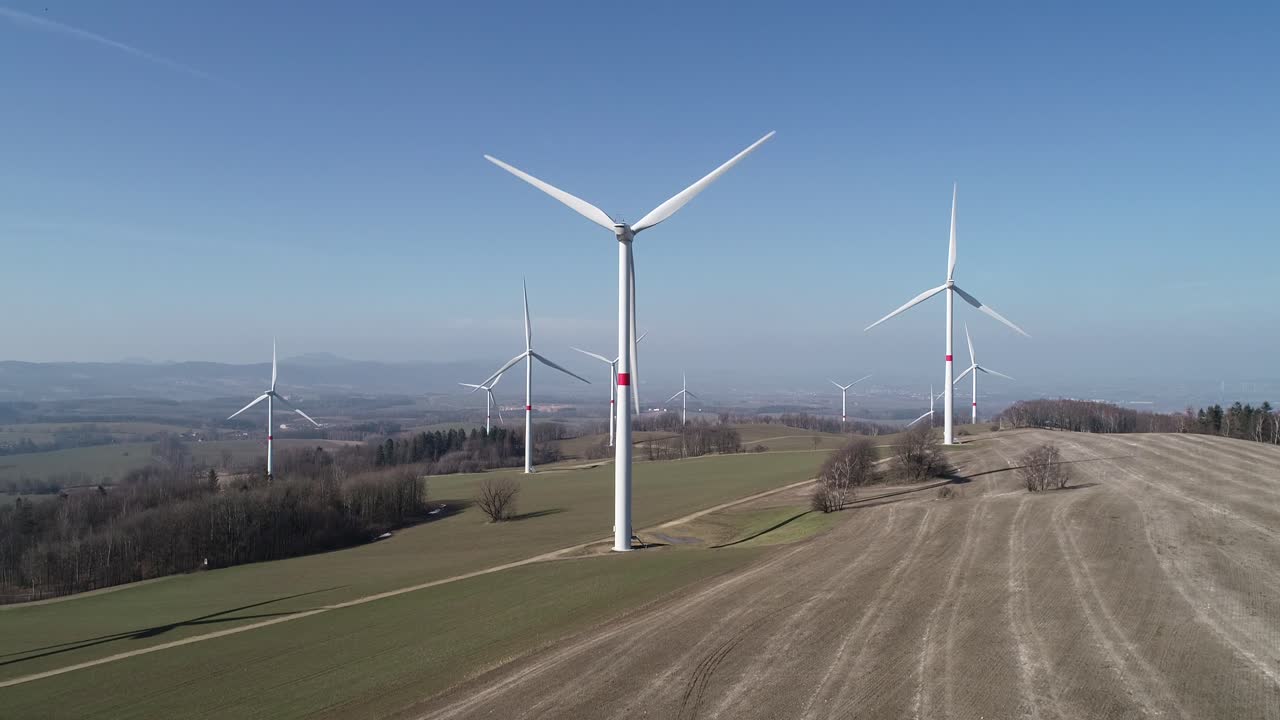 Aerial shot of windmills in the field creating green electricity