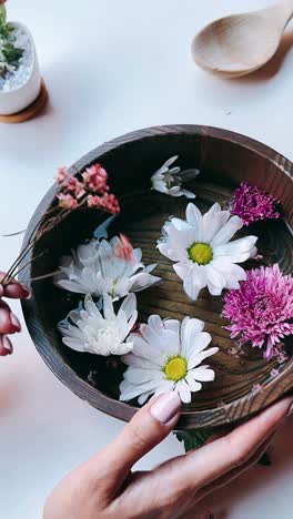 floral arrangement in a wooden bowl