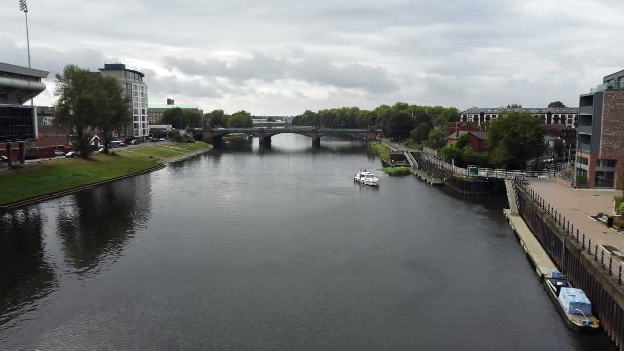 Drone Video of a River Boat preparing to Moor in Nottingham City Centre by London Road Vehicle Bridge. The footage moves backwards showing some of the City surroundings.