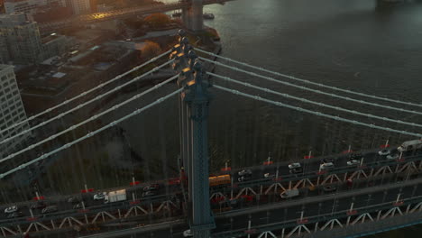 Heavy-traffic-on-Manhattan-Bridge.-Tilt-up-reveal-of-cityscape-against-setting-sun.-Manhattan,-New-York-City,-USA