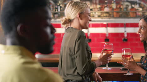 Two-Female-Friends-Meeting-For-Drinks-And-Socializing-In-Bar