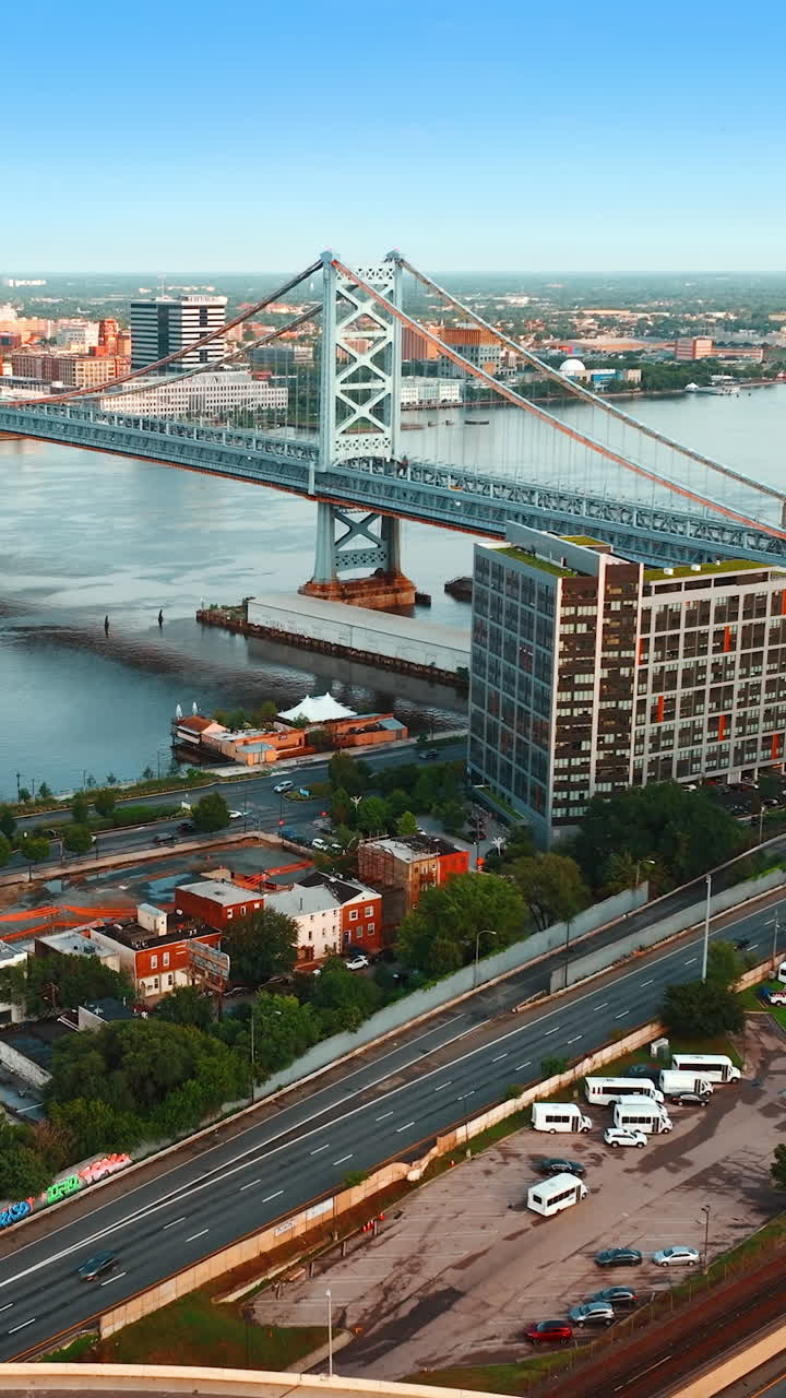 Scenery of the city with lively traffic. Aerial view of Ben Franklin Bridge in Philadelphia, Pennsylvania, USA. Vertical video