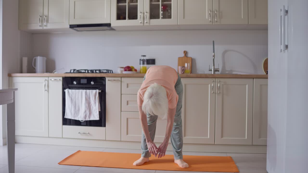 Senior Woman Exercising in Kitchen