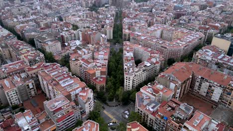 An-aerial-view-of-a-4-square-junction-road-with-high-rise-buildings-and-the-Sagrada-Familia-Cathedral-in-the-distance